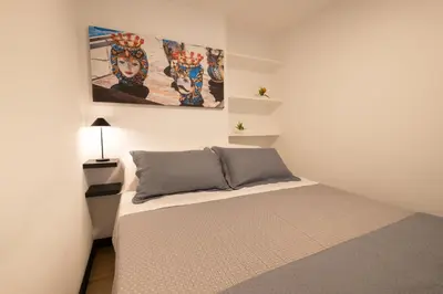 a bedroom with a bed and a painting on the wall at aprimaManu apartment in Monreale