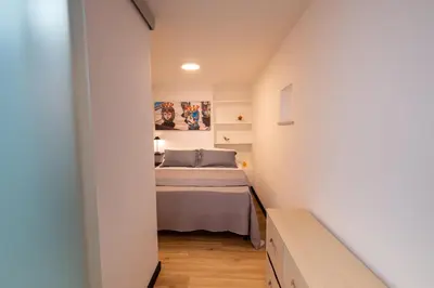 a bedroom with a bed in a small room at aprimaManu apartment in Monreale