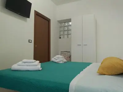 a bedroom with a bed with towels on it at Mo MA in Palermo