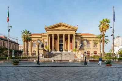 a building with palm trees in front of it at Mo MA in Palermo