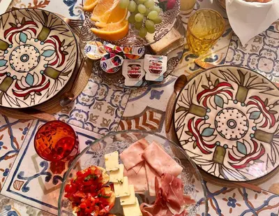 a table with plates of food and fruit on it at Antico Casale Formica in Bagheria