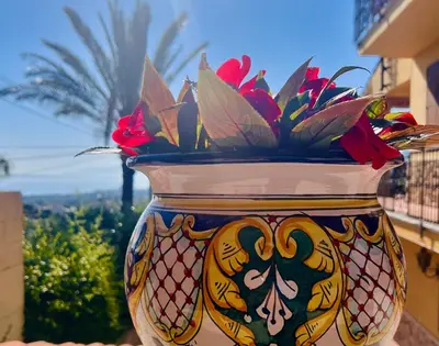 a vase with a flower arrangement in it at Antico Casale Formica in Bagheria