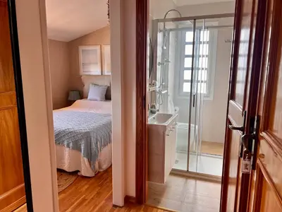 a bedroom with a bed and a glass shower at Antico Casale Formica in Bagheria
