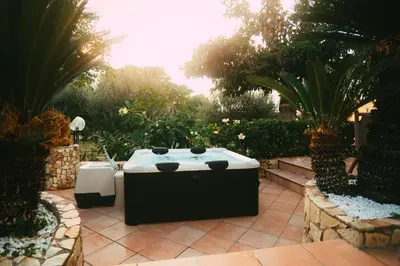 a black and white bath tub in a garden at VillaThomas in Campofelice di Roccella