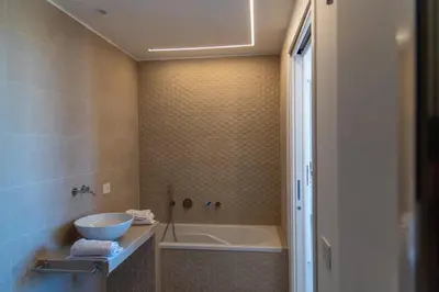 a bathroom with a tub and a sink and a bath tub at Tenuta Rapillo in Castellammare del Golfo