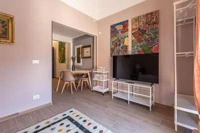 a living room with a large television and a table at Dasaro in Palermo