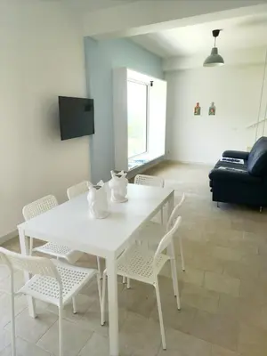 a white table and chairs in a living room at Castellammare Riviera in Alcamo Marina