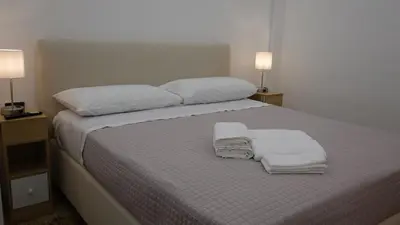 a bedroom with a bed with towels on it at AppartamentoBelgio in Palermo