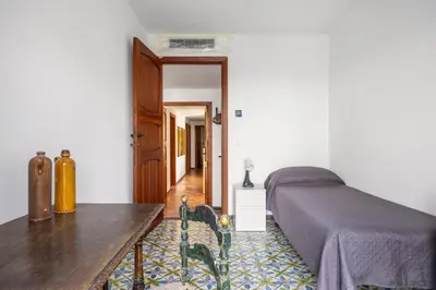 a bedroom with a bed and a wooden table at La Veranda Sul Mare in Santa Flavia