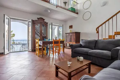 a living room with a couch and a table at La Veranda Sul Mare in Santa Flavia