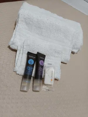 a group of toothbrushes and towels on a bed at B&B a casa di Peppe in Palermo