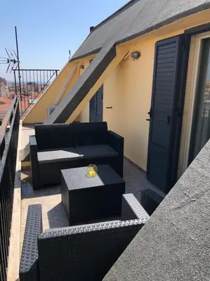 a patio with a couch and a table on a balcony at 7 floor in Palermo