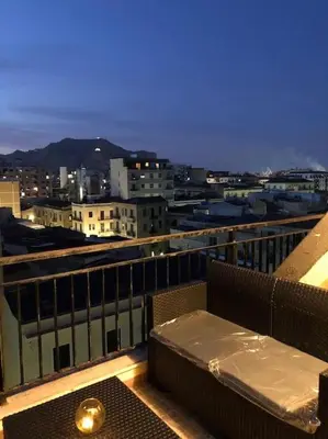 a balcony with a table and a view of a city at 7 floor in Palermo