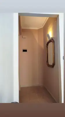 a hallway of a bathroom with a mirror and a door at 7 floor in Palermo