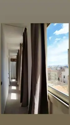 a window with curtains in a room with a view at 7 floor in Palermo