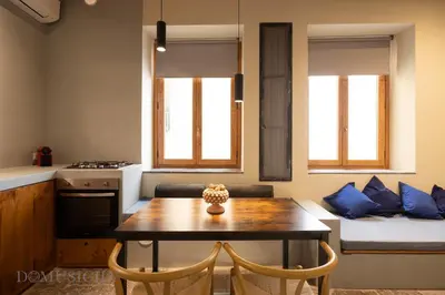 a small kitchen with a table and chairs and a couch at Lofterì by DomuSicily in Palermo