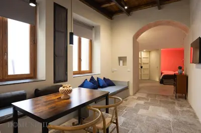 a living room with a table and a couch at Lofterì by DomuSicily in Palermo