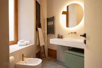 a bathroom with a sink and a mirror at Lofterì by DomuSicily in Palermo
