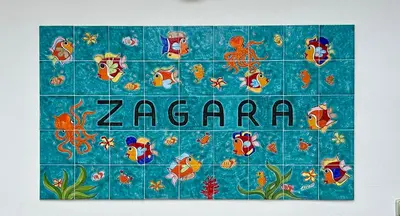 a blue tile with the word zazaria on it at Zagara in Palermo