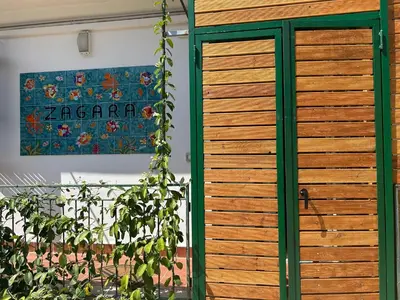 a wooden door in front of a wall with a painting at Zagara in Palermo