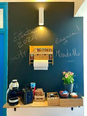 a black wall with writing on the wall at Zagara in Palermo