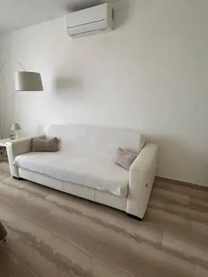 a white couch sitting in a living room at Attico con vista mozzafiato a due passi dal mare in Terrasini