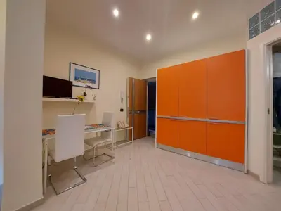 an office with a desk and orange cabinets in a room at Teatro Massimo - Apartment with Private Balcony in Palermo