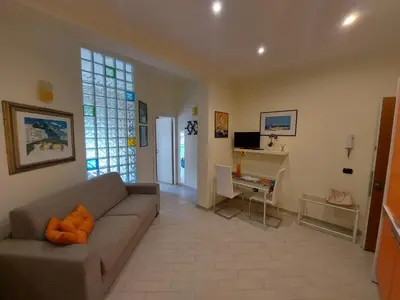 a living room with a couch and a desk at Teatro Massimo - Apartment with Private Balcony in Palermo