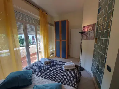 a room with a bed in a room with a window at Teatro Massimo - Apartment with Private Balcony in Palermo