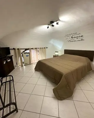 a bedroom with a bed on a tiled floor at politeama guest house il rifugio Palermo in Palermo