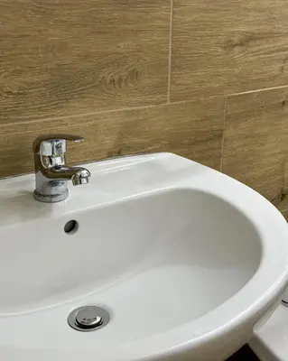 a white sink with a faucet in a bathroom at politeama guest house il rifugio Palermo in Palermo