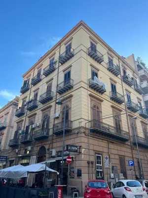 a tall building with cars parked in front of it at politeama guest house il rifugio Palermo in Palermo