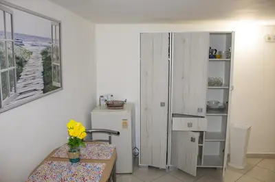 a kitchen with a table and a refrigerator at politeama guest house il rifugio Palermo in Palermo
