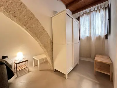 a room with a white cabinet and a window at Marcantonio Suite in Castellammare del Golfo