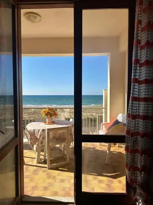 a room with a view of the ocean through a sliding glass door at Casa Letizia in Alcamo