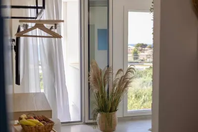 a kitchen with a bowl of fruit and a window at BellaVista in Cinisi