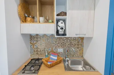 a kitchen with a sink and a counter top at BellaVista in Cinisi