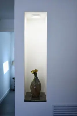 a vase sitting on a shelf in a room at Maciuni Apartment in Palermo