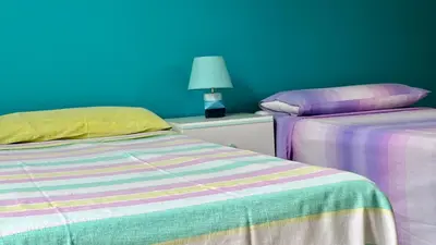 two beds sitting next to each other in a room at La Terrazza sul Mare in Palermo