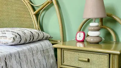 a bedside table with a lamp and a alarm clock at La Terrazza sul Mare in Palermo