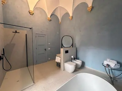 a bathroom with a tub and a toilet and a sink at Abbazia Santa Maria del Bosco in Contessa Entellina