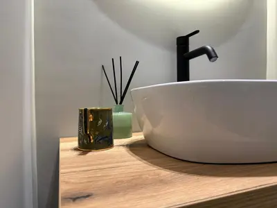 a bathroom counter with a sink and a faucet at Zahir Suite Apartment in Palermo
