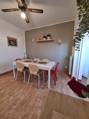 a dining room with a white table and chairs at CITY HOUSE & FREE PARKING by Perry-Holiday moderno, panoramico e comodo fino a 6 ospiti in Palermo