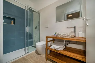 a bathroom with a shower and a toilet and a sink at Casa vinz in Scopello