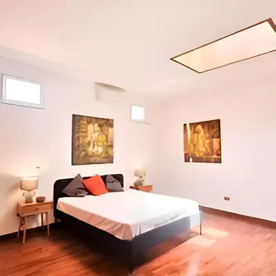 a bedroom with a bed and two paintings on the wall at Antico frantoio in Palermo