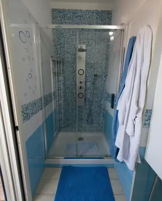a shower with a glass door in a bathroom at BluSunset Home Capaci in Capaci