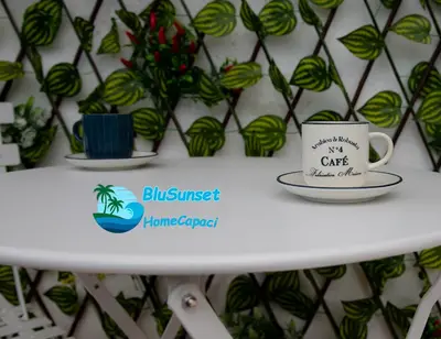 a white table with two cups on top of it at BluSunset Home Capaci in Capaci