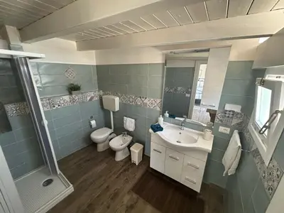 a bathroom with a toilet and a sink and a shower at Camera con terrazza in San Vito lo Capo