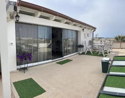 a patio with a view of a table and chairs at Camera con terrazza in San Vito lo Capo
