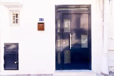a blue door on the side of a white building at Cappuccini 62 House in Palermo
